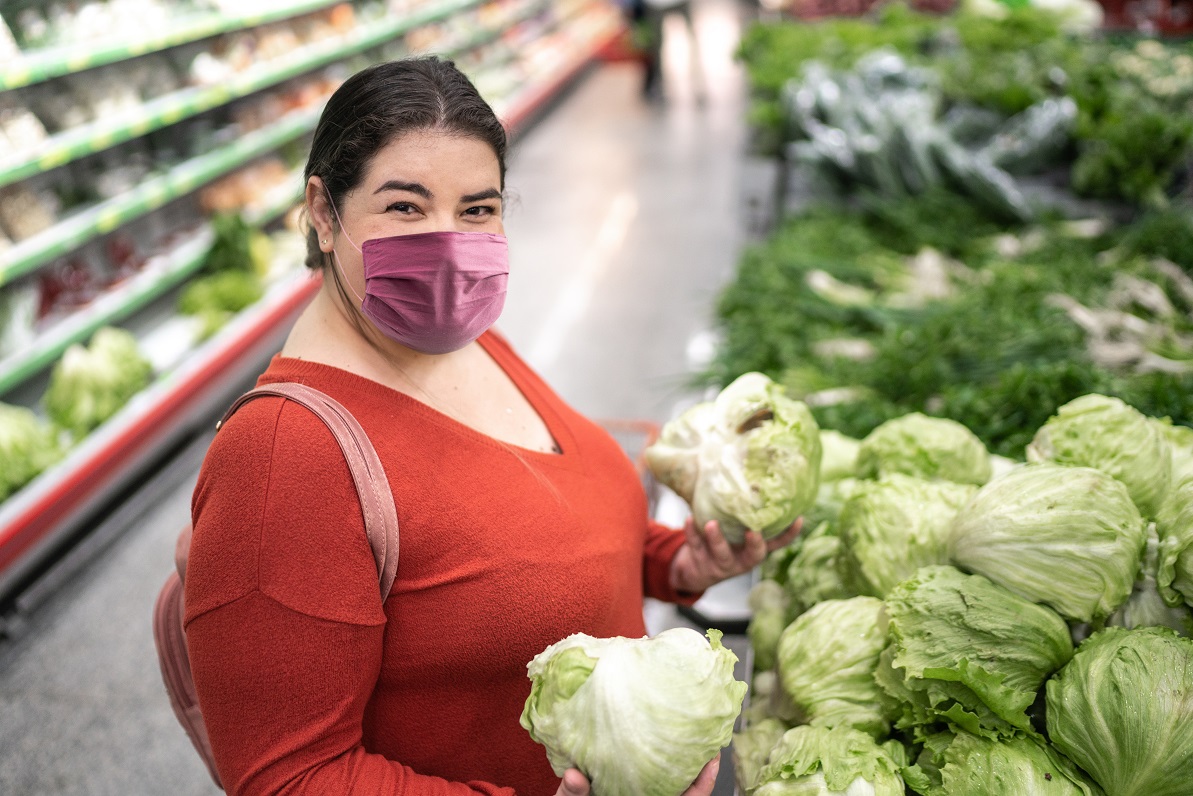 Woman holding groceries wearing mask