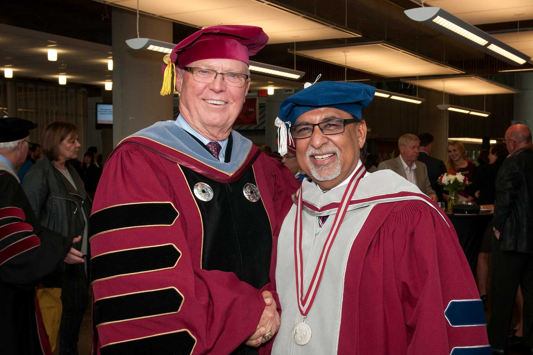 Dr. Arvinder Bubber (right) was awarded an honorary degree by his successor, Dr. George Melville.