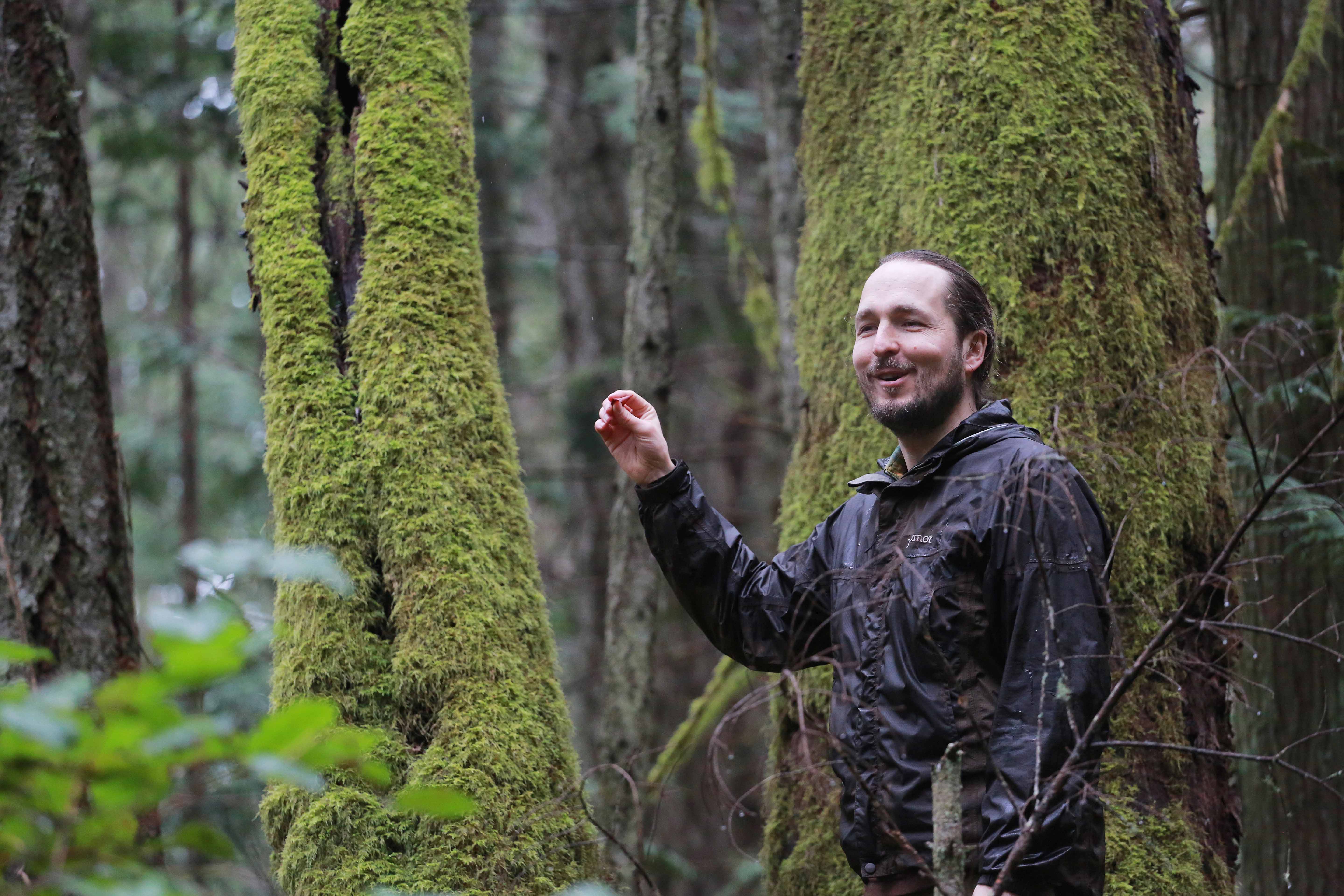 Dr. Lee Beavington teaching in a forest surrounded by moss-covered trees