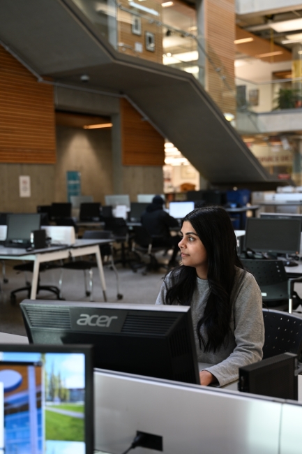 KPU student Akshleen Kaur works on computer in library.
