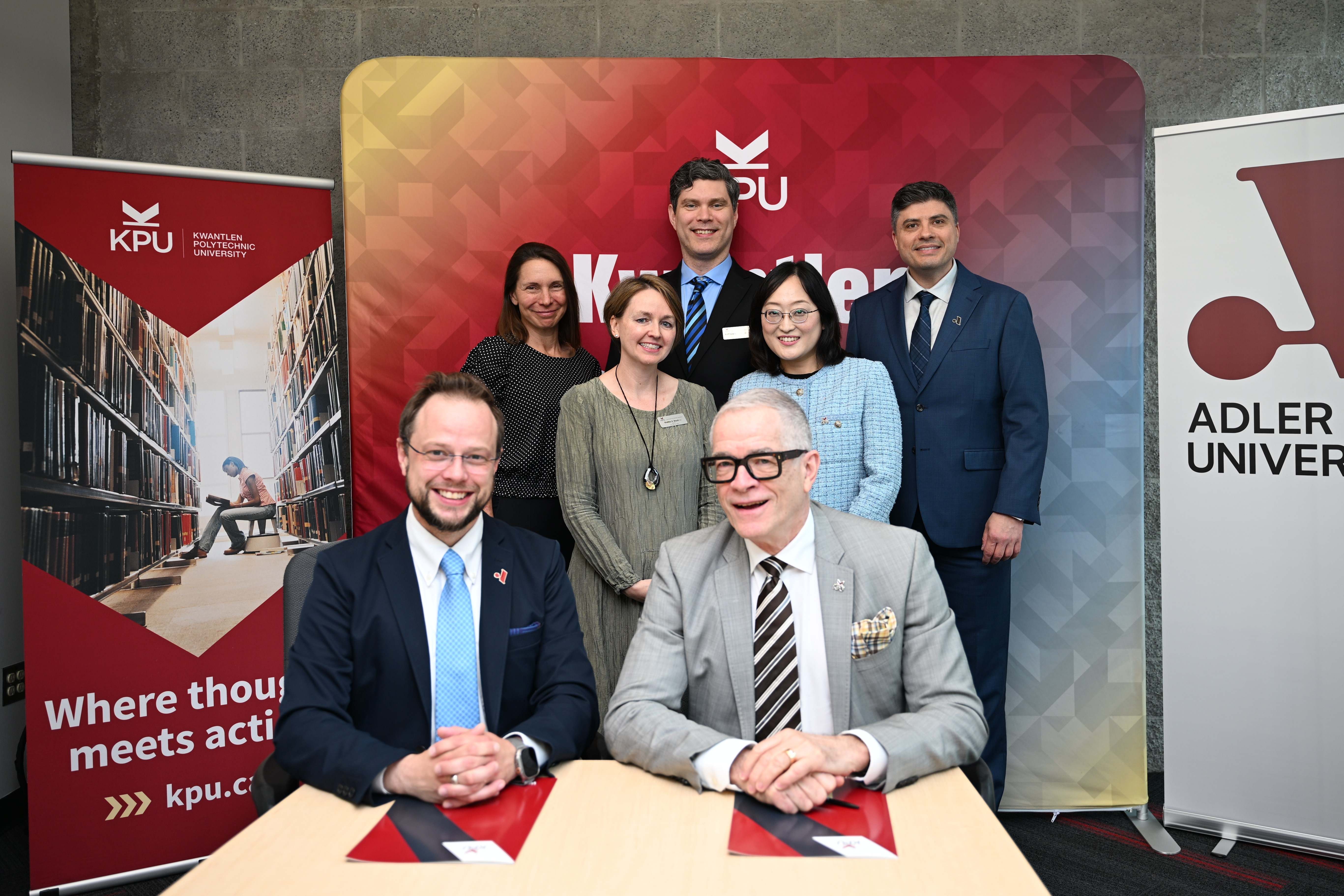 Representatives from KPU and Adler University mark the signing of a partnership agreement.