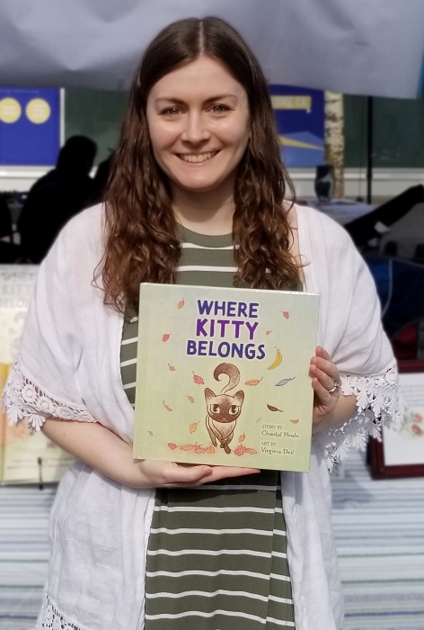 Chantal Houle holding book Where Kitty Belongs.