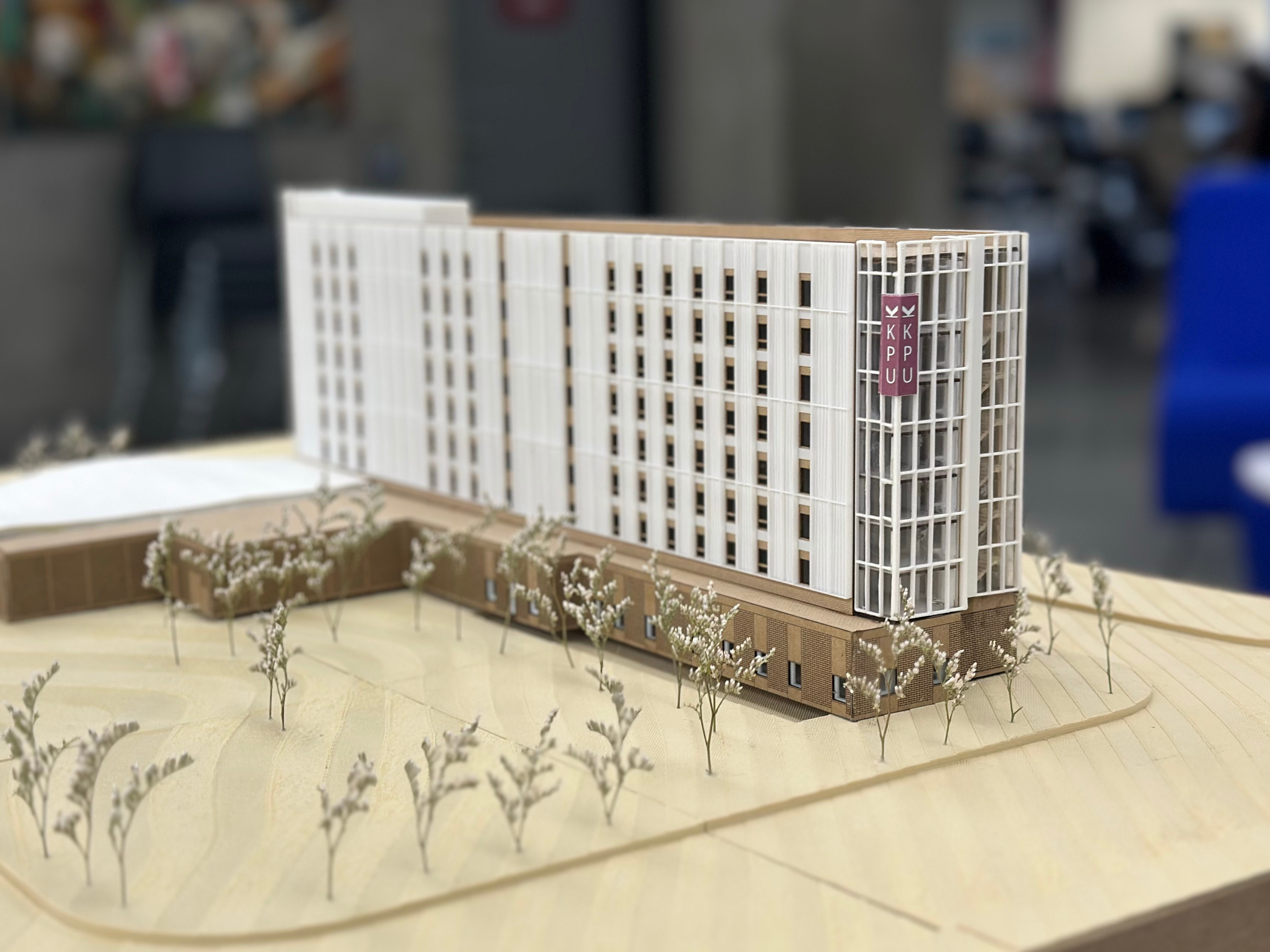 an architectural model of an eight-story building on a table