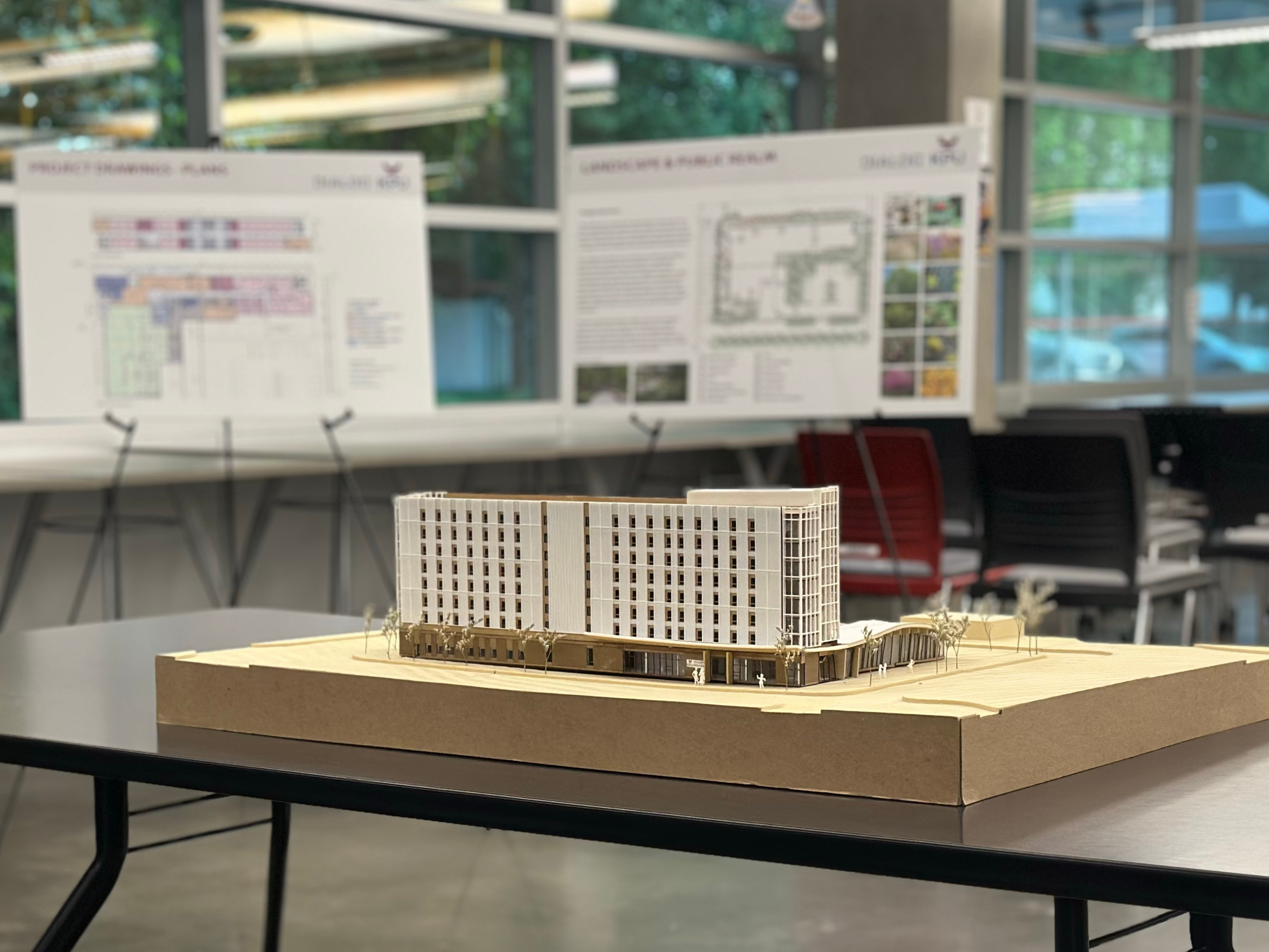 an architectural model of an eight-story building on a table