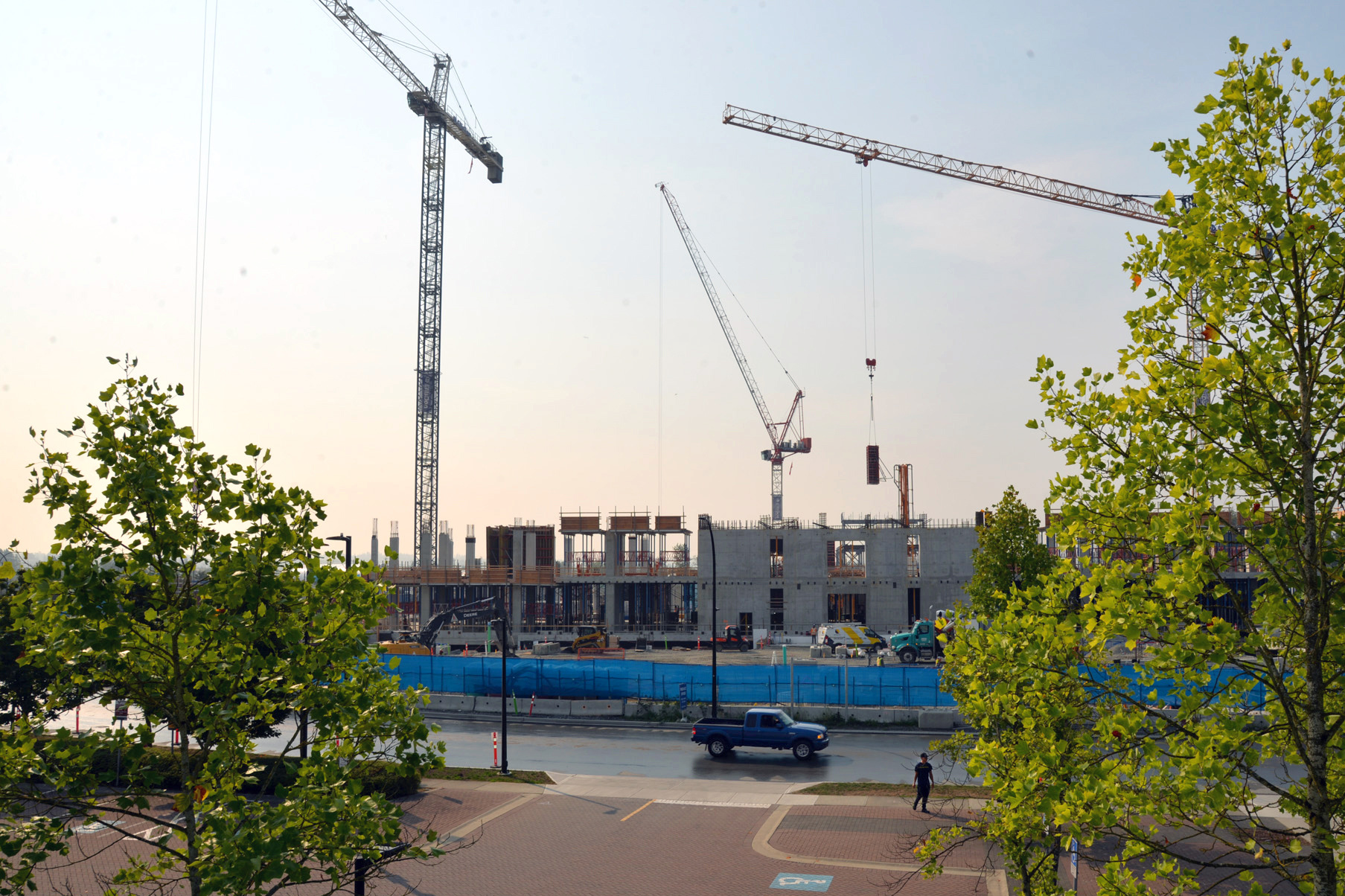 Cranes tower over a hospital construction site.