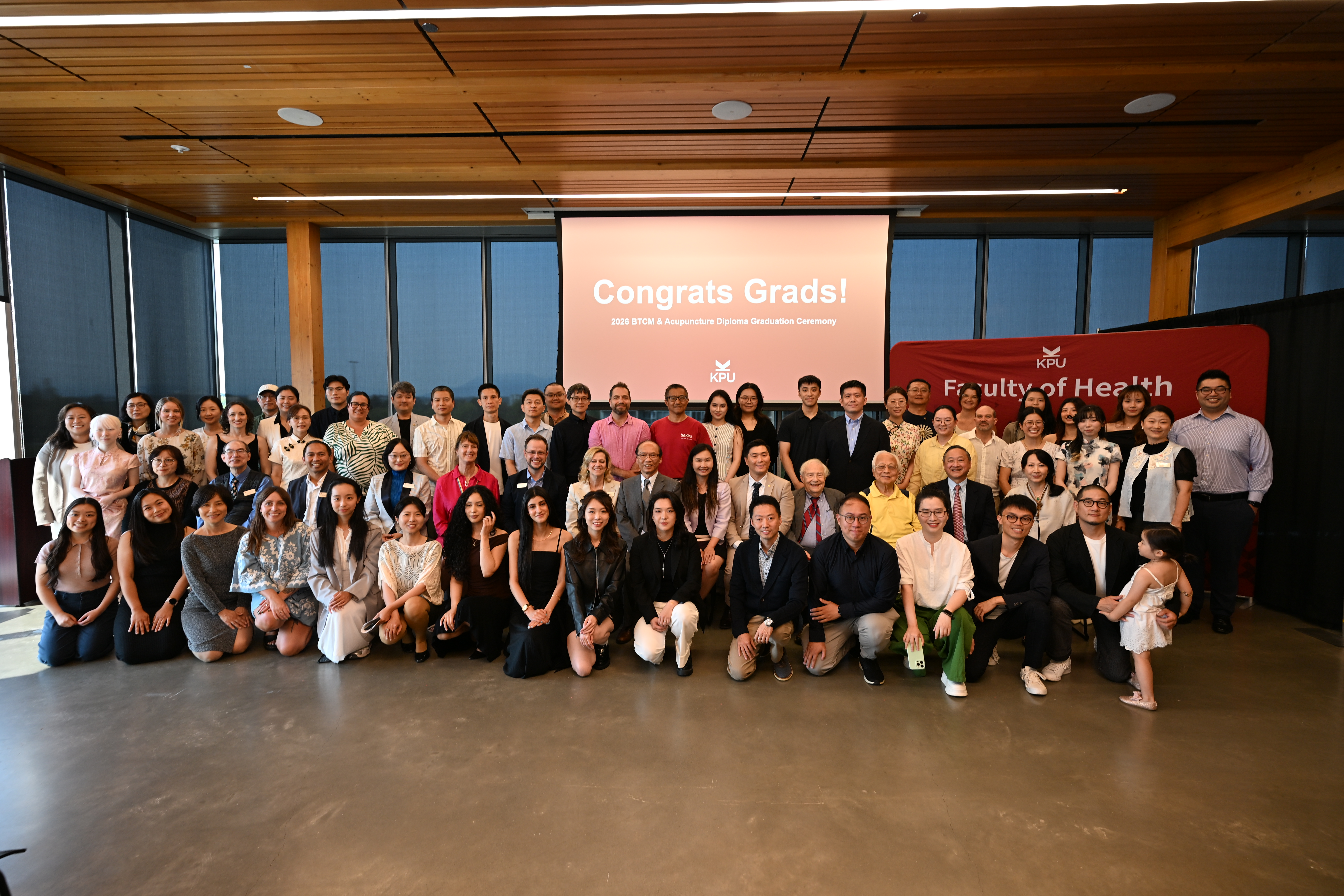 TCM students and faculty, and event dignitaries, in group photo.
