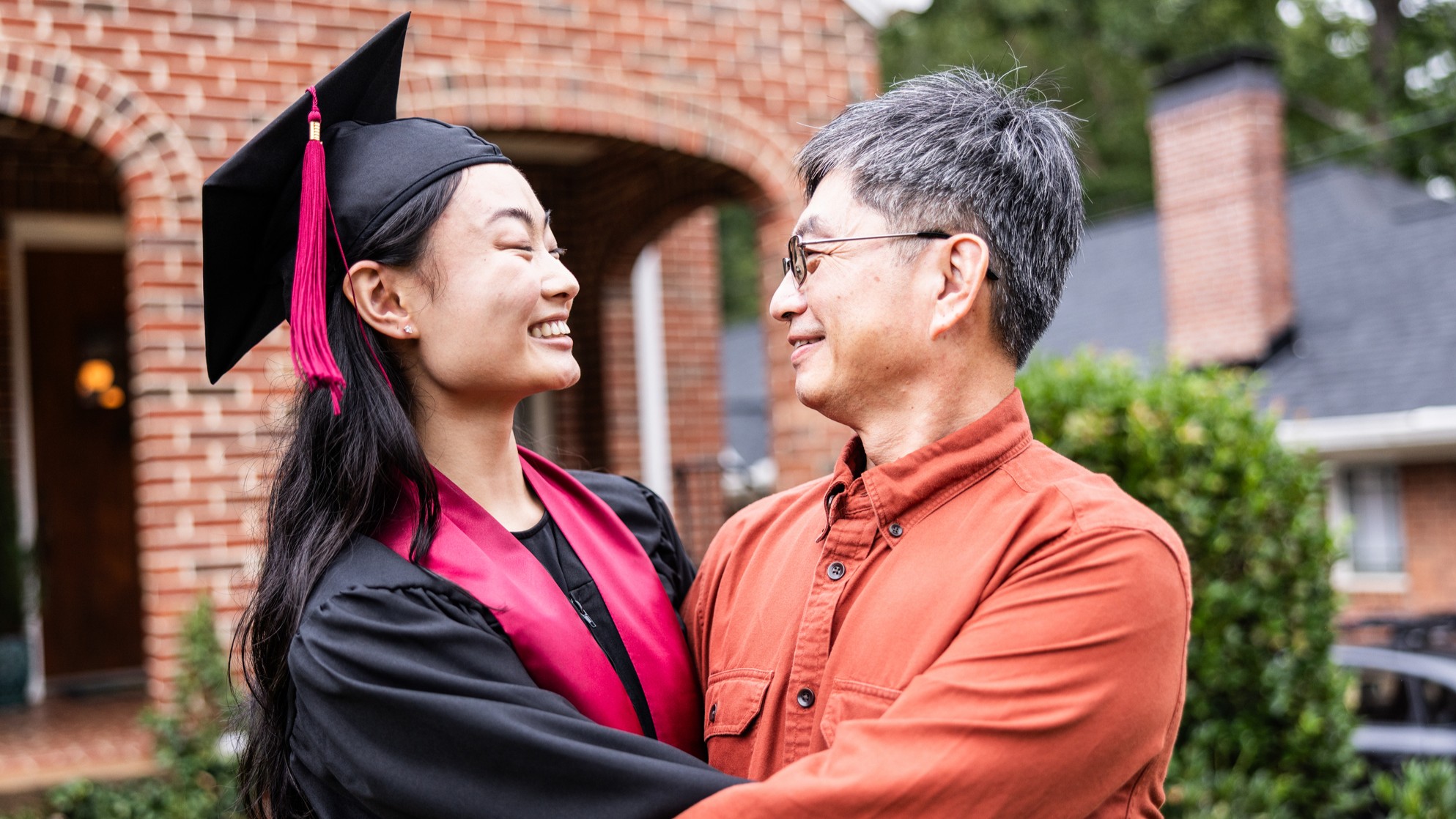 A father hugging his graduating daughter.