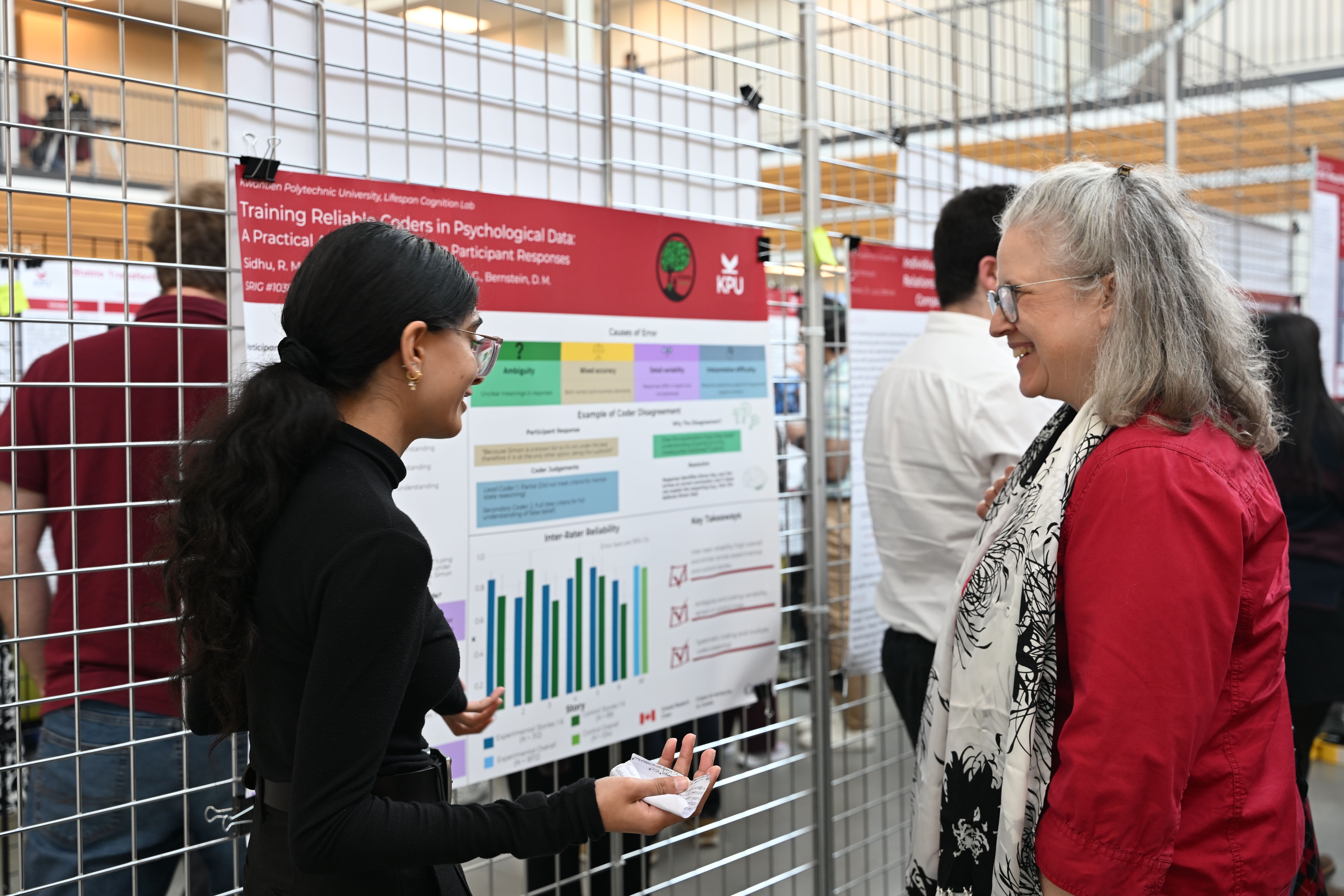 student shares their poster with an attendee
