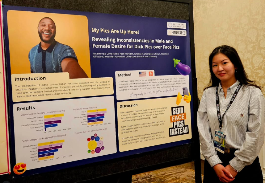 person standing in front of research poster at conference