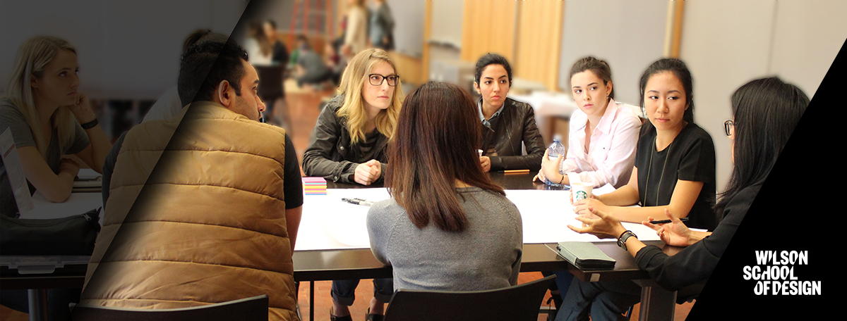 Group of students discussing things around a table.