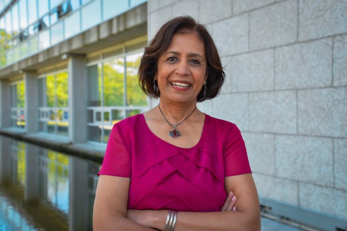 Dr. Gira Bhatt stands in front of fountain at KPU Surrey.