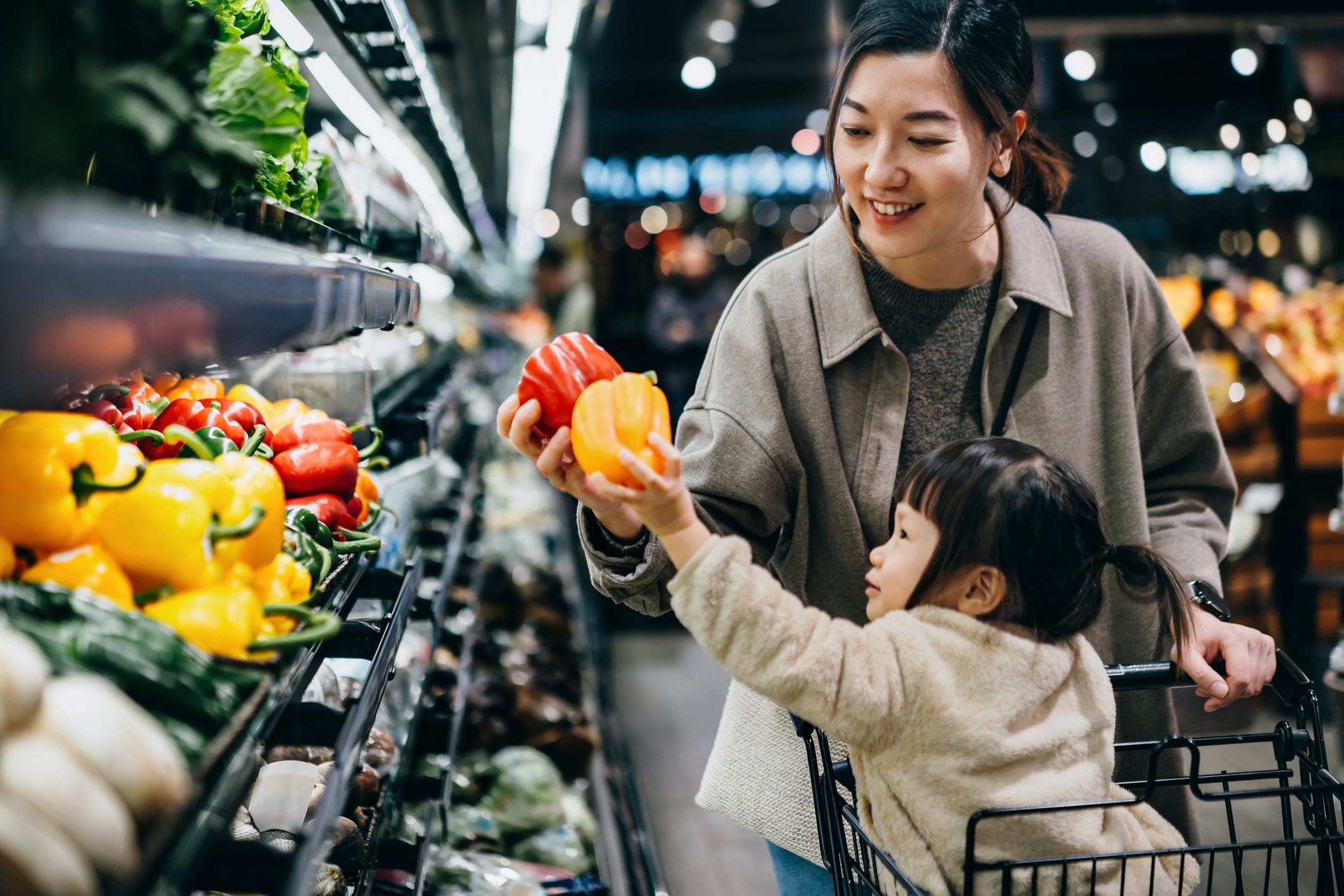 mother and daughter vegetable shopping