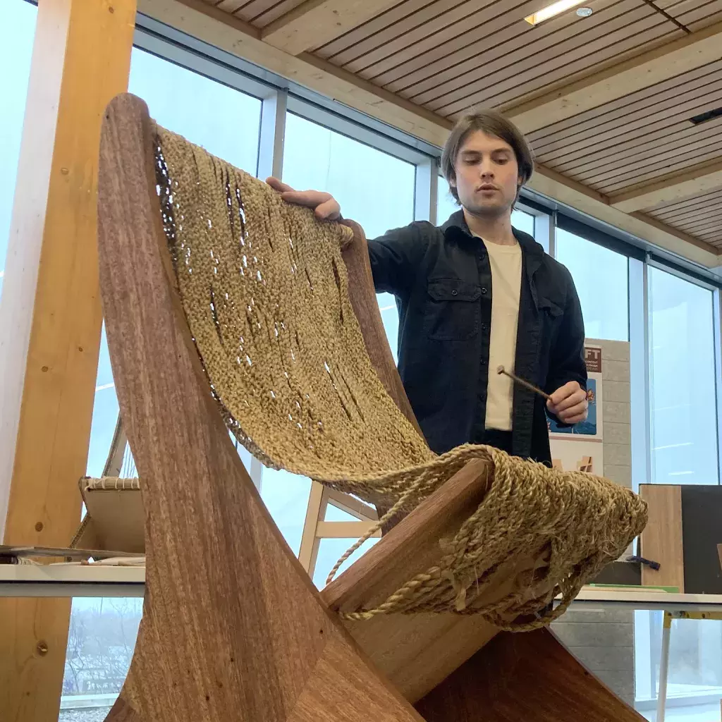 A product design student presents his mahogany chair.