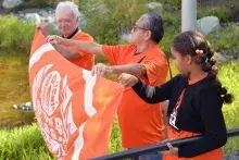 Dr. Alan Davis is joined by Elder in Residence Lekeyten by holding the orange flag