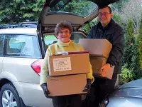 John Shepherd with fellow North Delta Rotary Club member Lornell Ridley carrying boxes of Rotary dictionaries.